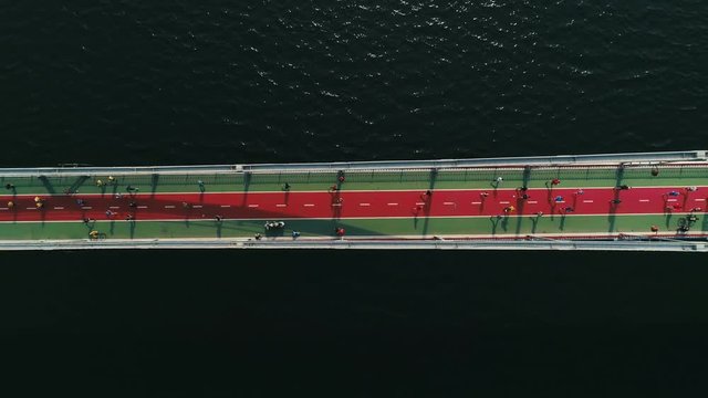 Marathon running on the footbridge. Top view shot