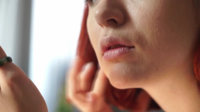 young woman applying makeup