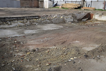 ruined foundation of an old building, the walls of the basement of a demolished building and debris.