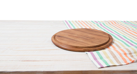 Empty tablecloth on wood table and pizza cutting board isolated on white background. Selective focus. Place for food. Top view. Mockup and template copy space. Banner