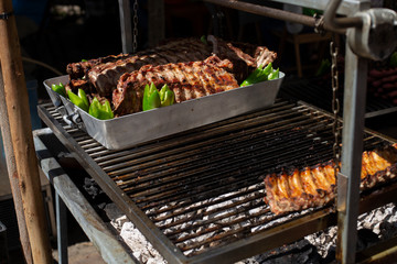 Several racks of pork spare ribs cooked on fire barbecue grill