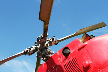 Red helicopter of air ambulance isolated on blue sky background. Detail of the helicopter blades. Cornwall, UK © Davide Zanin