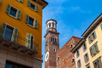 Obraz premium Verona, Italy – March 2019. Streets and buildings of ancient Verona city at the sunny summer day. Funny car by restourant