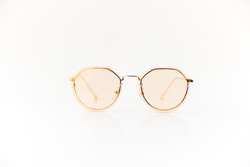 Isolated image of pink sunglasses with pink frame and gold color earpiece. Front view.