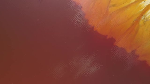 Aerial view of sterile toxic lake at copper exploitation. Diagonal abstract colors blending