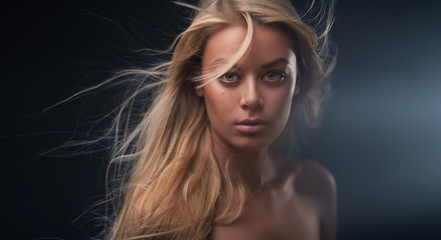 Portrait of a beautiful girl with flying blond hair