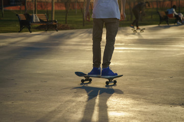 Fototapeta premium Image of skateboarders' legs and skate. 