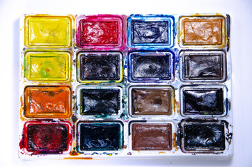 Palette with watercolors and brushes for paints on a white background. Watercolor paints. Brushes. Top and front view