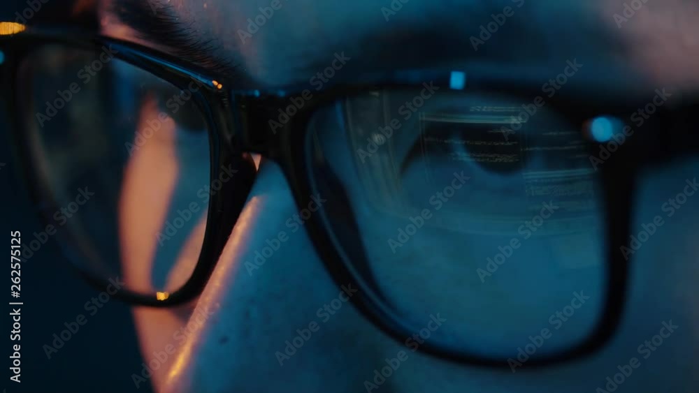 Poster vision, hacking and technology concept - close up of hacker eyes in glasses looking at computer scre
