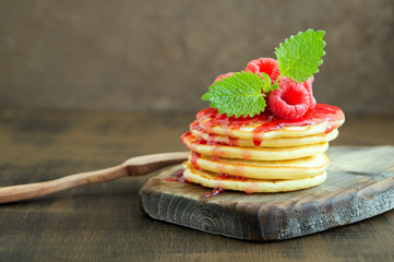 American pancakes with berries on a light background.