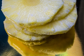 Slices of the fresh and cut pineapple on blue and bright background. Tropical, citrus fruit. A natural product for health. Exotic.