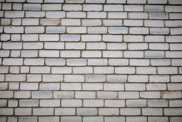 Wall is made from bricks and painted with white color.
