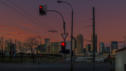 Traffic lights and beautiful red sunset sky behind it in the distance