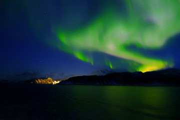 Northern lights  aurora borealis village ocean stars green night