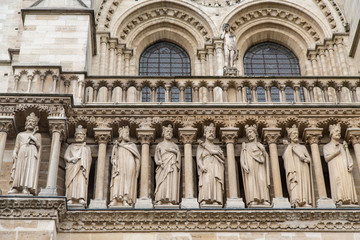 Fototapeta na wymiar Carved Statues on the Facade of Notre Dame Cathedral