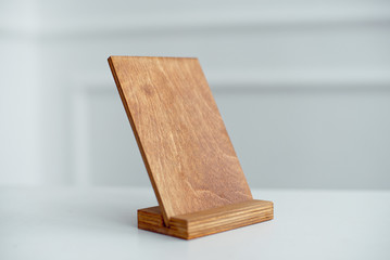 Vintage rectangular shaped wooden number buttons on a white wooden table