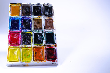 Palette with watercolors and brushes for paints on a white background. Watercolor paints. Brushes. Top and front view