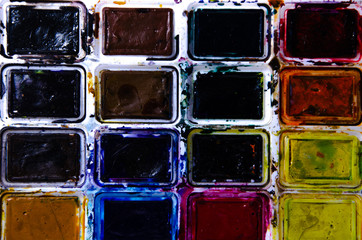 Palette with watercolors and brushes for paints on a white background. Watercolor paints. Brushes. Top and front view