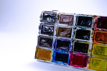 Palette with watercolors and brushes for paints on a white background. Watercolor paints. Brushes. Top and front view