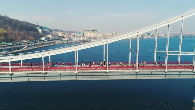 Marathon running on the footbridge. Dolly shot