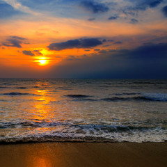 Beach of the ocean and red sunset.