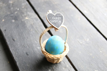 Happy Easter, a sign with an inscription and an egg in a basket