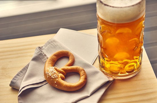 Sausages with potatoes and Pretzels Bavarian with a beer 