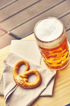 Sausages with potatoes and Pretzels Bavarian with a beer 