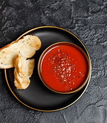 Traditional Spanish cold tomato soup gazpacho in a bowl on stone background. Traditional Spanish...