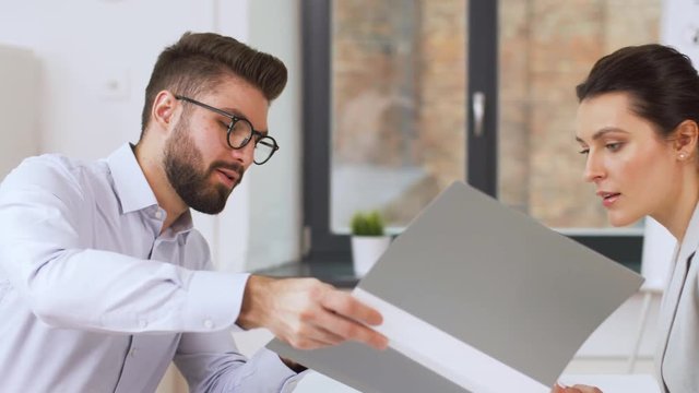 job, business and employment concept - female employer or hr manager having interview with male employee at office
