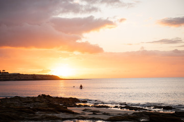 Fototapeta na wymiar siluet in a ocean sea against sun set 