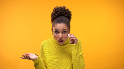 Indignant African-American lady looking through eyeglasses, unfair decision