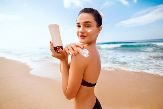 Back View of Young Woman Tanning at the Beach with Sunscreen Cream in Sun  Shape on Her Shoulder. UV Sunburn Protection and Stock Photo - Image of  healthy, person: 179198452