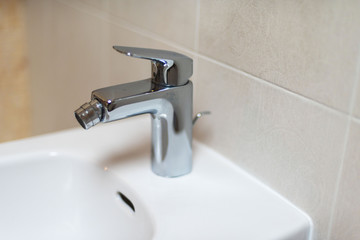 Fototapeta premium Sanitary fittings for bathrooms, faucets, shower cubicles, water taps, ceramic tiles and mosaics.