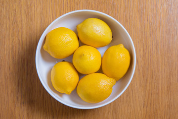 Fresh yellow lemons on a wooden background.. sweet lime, vitamin c.