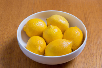 Fresh yellow lemons on a wooden background.. sweet lime, vitamin c.