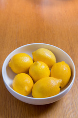 Fresh yellow lemons on a wooden background.. sweet lime, vitamin c.