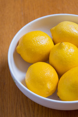 Fresh yellow lemons on a wooden background.. sweet lime, vitamin c.