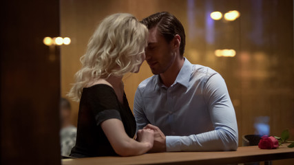 Loving couple of young people gently flirting and nuzzling, waking desire