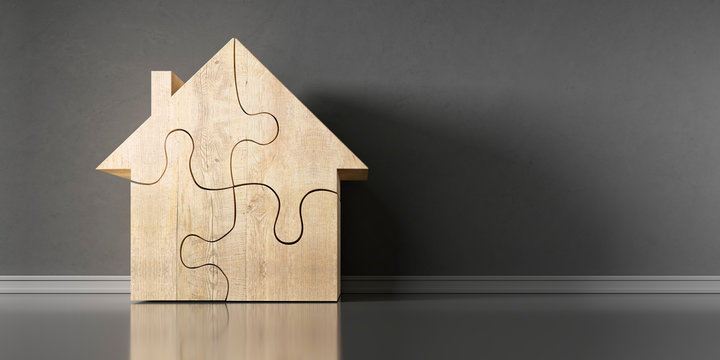 Haussymbol als Puzzle vor dunkler Wand
