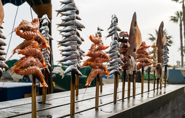 Seafood grilled on stick, close up view