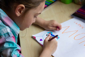 Child draws a postcard for mom