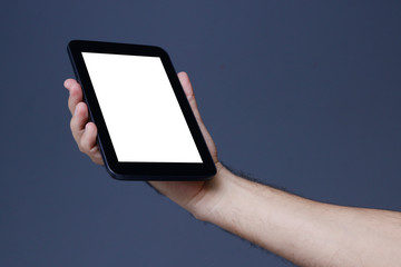 Hand holding tablet with clear screen at isolated background