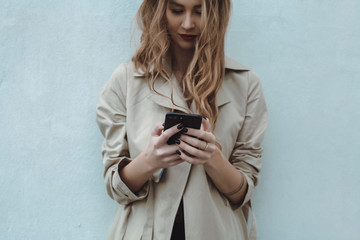 Fototapeta premium young pretty woman posing in the street with phone, outdoor portrait, hipster girls, sisters, chic, tablet, internet, using smartphone, close-up fashion model, post in instagram, facebook