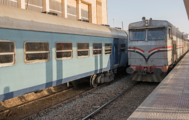 Fototapeta premium Railway locomotive and carriages at a station platform