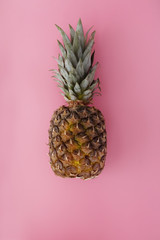 whole pineapple on a pink background