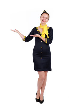 Stewardesse - Charming and smiling Stewardess Dressed In Blue Uniform Holding In Hand. Isolated on white backgroundv