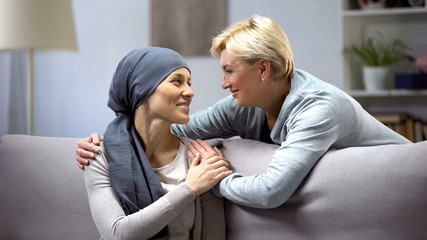 Smiling woman with cancer hugging mother, hope and togetherness, remission - 262591728