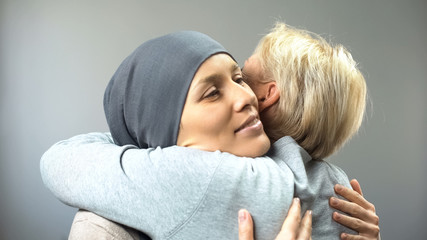 Smiling woman with cancer hugging her female friend, hope for cure, support