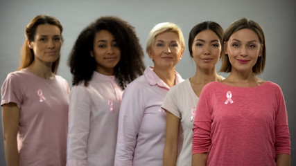 Group of women wearing pink clothes and ribbons, fighting against breast cancer